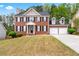 Charming two-story brick home with a manicured lawn and a two-car attached garage at 642 Towering Pine Trl, Lawrenceville, GA 30045