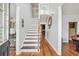 Welcoming foyer with hardwood floors, staircase, and view into the kitchen at 642 Towering Pine Trl, Lawrenceville, GA 30045