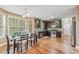 Open kitchen with stainless appliances, dark cabinets, hardwood floors and breakfast nook at 642 Towering Pine Trl, Lawrenceville, GA 30045