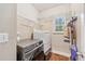 Convenient laundry room featuring a modern washer and dryer and extra shelving at 642 Towering Pine Trl, Lawrenceville, GA 30045