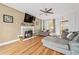 Cozy living room featuring fireplace, hardwood floors, and comfortable seating arrangement at 642 Towering Pine Trl, Lawrenceville, GA 30045