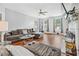 Comfortable living room featuring hardwood floors, a ceiling fan, and a large couch at 642 Towering Pine Trl, Lawrenceville, GA 30045