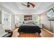 Large primary bedroom with tray ceilings, hardwood floors, and an en-suite bathroom at 642 Towering Pine Trl, Lawrenceville, GA 30045