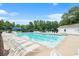 Community swimming pool features rows of lounge chairs and lush green trees at 642 Towering Pine Trl, Lawrenceville, GA 30045