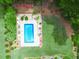 An aerial shot showcases a private backyard oasis with a sparkling pool and lounge area at 811 Ivy Ridge Dr, Loganville, GA 30052