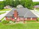Aerial view of brick home with manicured lawn, deck with patio furniture and privacy fence at 811 Ivy Ridge Dr, Loganville, GA 30052