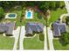 An aerial view showcases home, lush landscaping, and the sparkling blue swimming pool at 811 Ivy Ridge Dr, Loganville, GA 30052