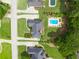 Aerial view showcasing the property's layout with the pool, houses, and well-manicured lawns at 811 Ivy Ridge Dr, Loganville, GA 30052
