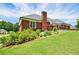 Beautiful backyard with a brick home, lush green grass, and mature trees at 811 Ivy Ridge Dr, Loganville, GA 30052