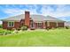 Expansive backyard featuring a brick house, lush green lawn, and wood deck at 811 Ivy Ridge Dr, Loganville, GA 30052