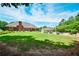 Lush backyard featuring a spacious lawn, mature trees, and partial fencing at 811 Ivy Ridge Dr, Loganville, GA 30052