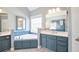 Bathroom with soaking tub, double vanity with framed mirror, and neutral paint at 811 Ivy Ridge Dr, Loganville, GA 30052