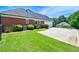 Brick home with a well-maintained yard and long driveway to an attached garage at 811 Ivy Ridge Dr, Loganville, GA 30052