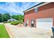 The exterior shows a brick home with an attached garage and long driveway on a sunny day at 811 Ivy Ridge Dr, Loganville, GA 30052