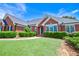 Charming brick home featuring lush green lawn, mature landscaping, and inviting entrance at 811 Ivy Ridge Dr, Loganville, GA 30052