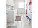 Well-equipped laundry room with washer, dryer, and storage shelving at 811 Ivy Ridge Dr, Loganville, GA 30052