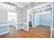 Bright living room with hardwood floors, open doorway, and modern lighting fixtures throughout home at 811 Ivy Ridge Dr, Loganville, GA 30052