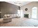 Spacious living room with fireplace, neutral tones, and tall ceilings providing an airy and inviting space at 811 Ivy Ridge Dr, Loganville, GA 30052