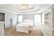 Serene main bedroom retreat with tray ceilings, bright windows, and all-white furniture at 811 Ivy Ridge Dr, Loganville, GA 30052