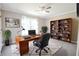 Bright office with a large window, wood desk, and built-in shelves, plus a decorative rug at 811 Ivy Ridge Dr, Loganville, GA 30052