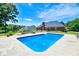 Backyard view showcasing the inviting pool, manicured lawn, and brick home at 811 Ivy Ridge Dr, Loganville, GA 30052