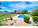 Backyard pool and patio area are surrounded by lush landscaping, trees, and a brick home at 811 Ivy Ridge Dr, Loganville, GA 30052