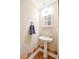 Charming powder room featuring pedestal sink and whimsical border design at 811 Ivy Ridge Dr, Loganville, GA 30052