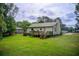 Large grassy backyard with a deck and lush greenery surrounding the property at 173 Elder Dr, Social Circle, GA 30025