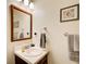 Well-lit bathroom with a single sink, neutral paint, and a framed seashell print at 173 Elder Dr, Social Circle, GA 30025