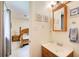 Cozy bathroom featuring a wood vanity, framed mirror, and tasteful decorative art above toilet at 173 Elder Dr, Social Circle, GA 30025