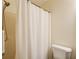Bathroom featuring a shower with a white shower curtain and a white toilet at 173 Elder Dr, Social Circle, GA 30025