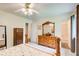 Bright bedroom with ceiling fan, light walls, carpet flooring, and wooden furniture at 173 Elder Dr, Social Circle, GA 30025