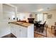 View of the dining area with wood floors and a glimpse of the living room at 173 Elder Dr, Social Circle, GA 30025