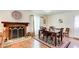 Dining area features a fireplace, hardwood floors, and a stylish dining table with seating for six at 173 Elder Dr, Social Circle, GA 30025