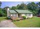 Beautiful home featuring a metal roof, a lovely green lawn, and a welcoming wooden deck at 173 Elder Dr, Social Circle, GA 30025