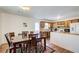 Kitchen with dining table, featuring wooden cabinets and views of the backyard at 173 Elder Dr, Social Circle, GA 30025