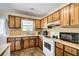 Functional kitchen with wooden cabinets, modern appliances, and ample counter space for meal preparation at 173 Elder Dr, Social Circle, GA 30025