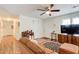 Inviting living room with hardwood floors, ceiling fan and a neutral color palette at 173 Elder Dr, Social Circle, GA 30025