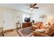 Cozy living room featuring hardwood floors, a ceiling fan, and comfortable seating arrangement at 173 Elder Dr, Social Circle, GA 30025