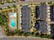 Aerial view of community pool, clubhouse and townhomes in neighborhood at 323 Concord St, Alpharetta, GA 30009