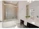 This bathroom features a shower and tub combination with a glass door and gray vanity at 323 Concord St, Alpharetta, GA 30009