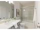 This full bathroom features a shower and tub combination and gray vanity with white counter at 323 Concord St, Alpharetta, GA 30009
