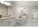 Bathroom with dual sink vanity, soaking tub and view to the entryway of another room at 323 Concord St, Alpharetta, GA 30009