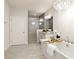 Bright bathroom featuring a soaking tub, a crystal chandelier, and a patterned tile shower at 323 Concord St, Alpharetta, GA 30009