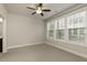 Neutral bedroom with three large windows and a ceiling fan at 323 Concord St, Alpharetta, GA 30009