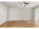 Spacious bedroom with beautiful hardwood floors and a ceiling fan, ready for your personal touch at 323 Concord St, Alpharetta, GA 30009