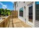 Outdoor wooden deck that looks out onto wooded area, white exterior of the home, and a screen door at 323 Concord St, Alpharetta, GA 30009