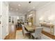 Open dining area leading to kitchen with hardwood floors and modern light fixture at 323 Concord St, Alpharetta, GA 30009