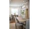 Open concept dining area showing a modern table and decor leading into the kitchen area at 323 Concord St, Alpharetta, GA 30009