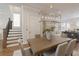 Dining area featuring a modern table, chandelier, hardwood floors, and sightlines to the kitchen at 323 Concord St, Alpharetta, GA 30009